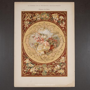 May include: An antique print from "Le Journal de la Décoration" featuring a floral painting. The artwork showcases a central arrangement of roses and other flowers in a circular frame, surrounded by a decorative border with floral motifs. The color palette includes cream, red, and brown.