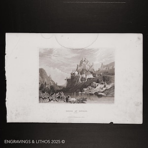 May include: A black and white engraving of a city on a hill overlooking a river. The city is surrounded by a wall and has several buildings with domes. The river is in the foreground and there are trees and rocks on the banks.