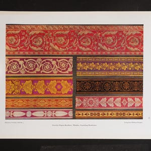 May include: A vintage print displaying various decorative border designs. The borders feature ornate patterns in red, gold, purple, and black, with floral and geometric motifs. The print includes text at the bottom.