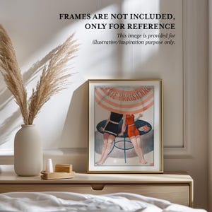 a framed vintage poster of two women in swimsuits, placed on a wooden dresser next to a vase with dried reeds.