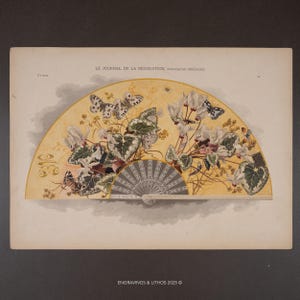 May include: A vintage illustration of a hand fan with a floral and butterfly design. The fan features a cream-colored background with white flowers, green leaves, and butterflies. The text "LE JOURNAL DE LA DÉCORATION, PUBLICATION PÉRIODIQUE" is visible.