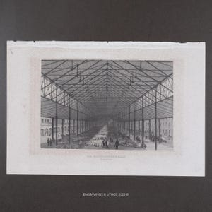 May include: A black and white engraving depicting the interior of a large market hall with a high, vaulted iron truss roof supported by thin columns. People are walking among rows of stalls on the floor. The text reads Die SCHRANNENHALLE in MÜNCHEN.