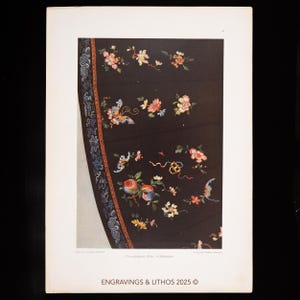May include: A detail of a black textile with colorful floral and butterfly embroidery. The design includes pink, orange, and yellow flowers, along with blue and orange butterflies. The edge features a blue and red patterned border. The text "ENGRAVINGS & LITHOS 2025 ©" is at the bottom.