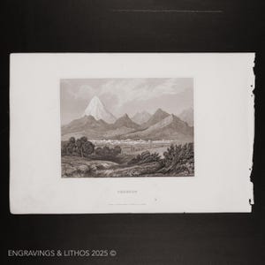 May include: A black and white engraving of a mountain range with a town in the valley below. The engraving is titled "T'CHIKAM."