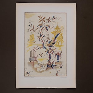 May include: A vintage print featuring an Asian-inspired design. The artwork depicts a bird perched on a branch, a pagoda, a sailboat, and a birdcage. The color palette includes shades of blue, yellow, and brown. The print is framed in white.