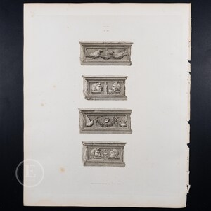 May include: A black and white engraving of four different architectural details. Each detail is a rectangular block with a different design. The top detail features two birds facing each other. The second detail features two human heads. The third detail features a wreath of leaves and two birds. The bottom detail features two human heads.