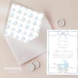 Sweeten Studio's template which includes a soft pastel blue watercolor background with a subtle fabric texture, a carriage, and a delicate blue ribbon-style border, sized for a 5x7 baby shower invitation.