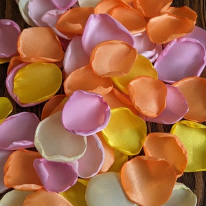 Pink orange and yellow mixture of rose petals for wedding decor