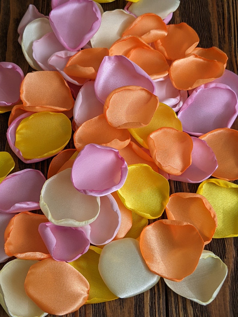 Pink orange and yellow mixture of rose petals for wedding decor