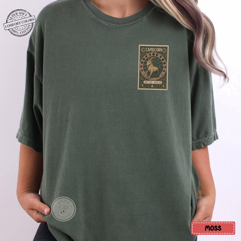 Puede incluir: Camiseta verde musgo con un dise&ntilde;o gr&aacute;fico del signo zodiacal Capricornio. El dise&ntilde;o rectangular presenta una ilustraci&oacute;n de una cabra, la palabra "CAPRICORN" y las fechas "DEC 22 - JAN 19". La camiseta tiene un corte holgado y mangas cortas.