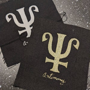 Antimon Alkemi Symbol Tyglapp