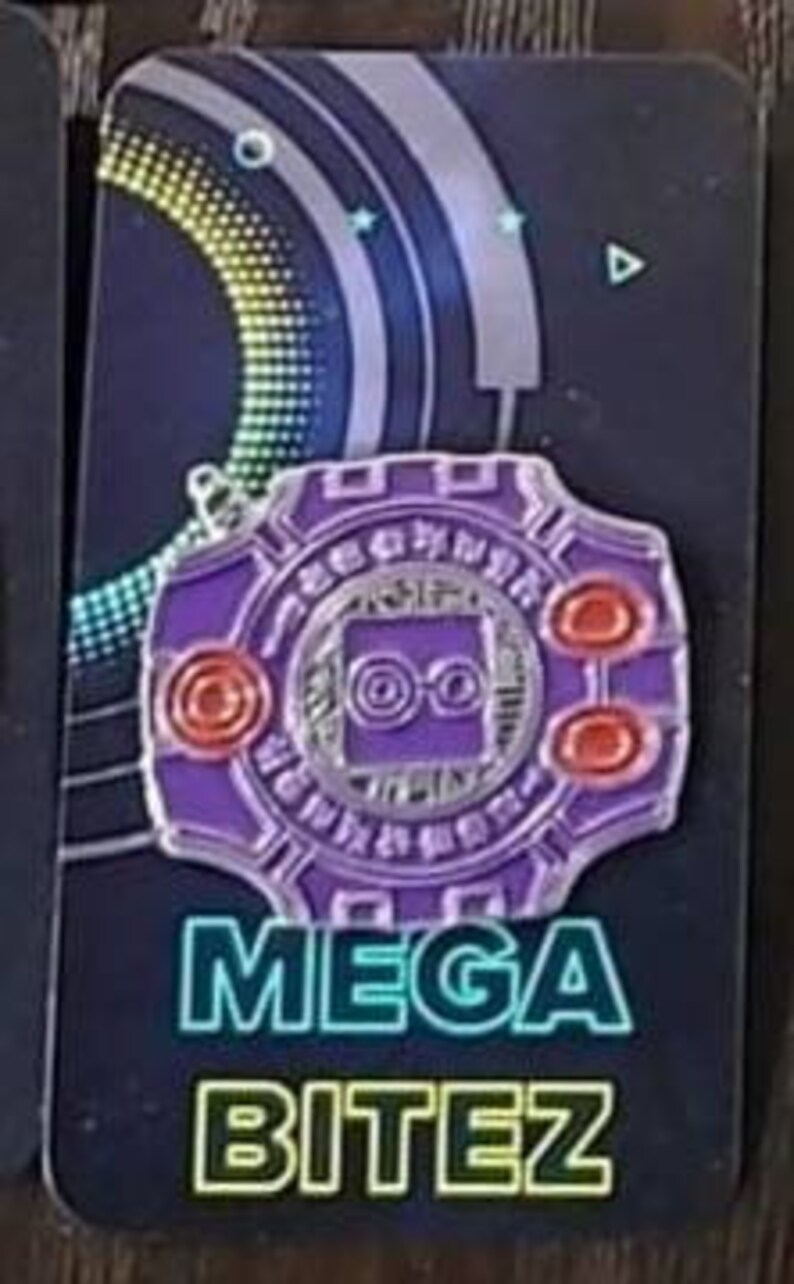 May include: Purple and silver enamel pin with a stylized design of a computer chip and the text "MEGA BITEZ".