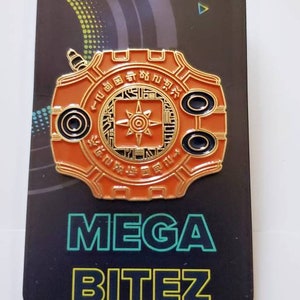 May include: Orange and gold Digimon pin with the text "MEGA BITEZ" in green and blue. The pin features a Digimon device with Japanese text.