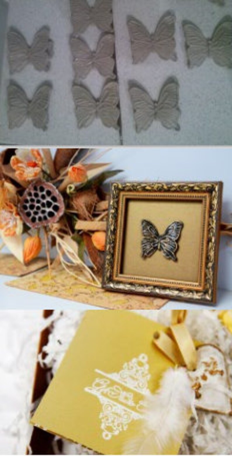 May include: A gold-framed picture with a black butterfly design on a gold background. The frame has a decorative, ornate design. The picture is sitting on a table with a gold and white card with a decorative design.
