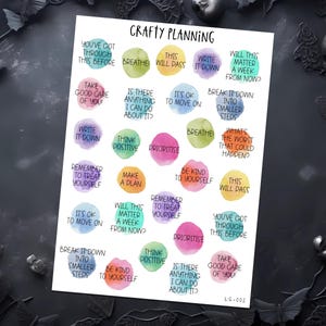 May include: A planner sticker sheet with a white background, featuring colourful watercolour circles with motivational phrases such as "Breathe" and "Think Positive." The sheet is labelled "Crafty Planning" and includes the code "LS-002".