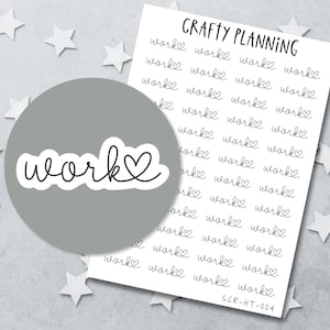 May include: A white sticker sheet titled CRAFTY PLANNING featuring multiple rows of black text stickers that read work with a heart symbol. A single, larger die-cut sticker showing the word work with a heart is layered over the sheet.