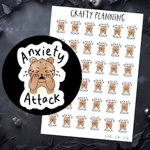 Puede incluir: Hoja de pegatinas para planificador con un oso de dibujos animados y el texto "Anxiety Attack". Las pegatinas son marrones, negras y blancas. La hoja está etiquetada como "Crafty Planning" y tiene un código de producto.
