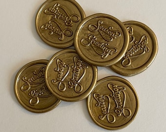 May include: A set of six gold wax seals with the text "Season's Greetings" embossed on each.