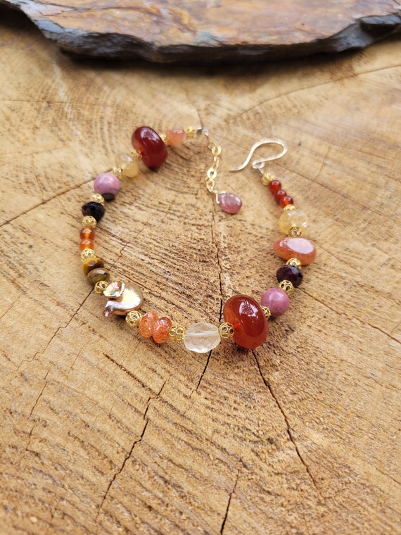 Loaded gold gemstone bracelet. Stunning natural gemstones in gold filled. Oranges and creams and yellows and reds. Gorgeous bracelet