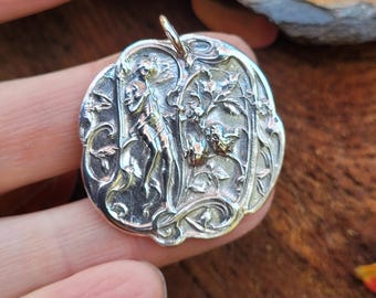 1900's French art nouveau pendant necklace. Sterling silver garden fairy is playing the double flute or aulos.
