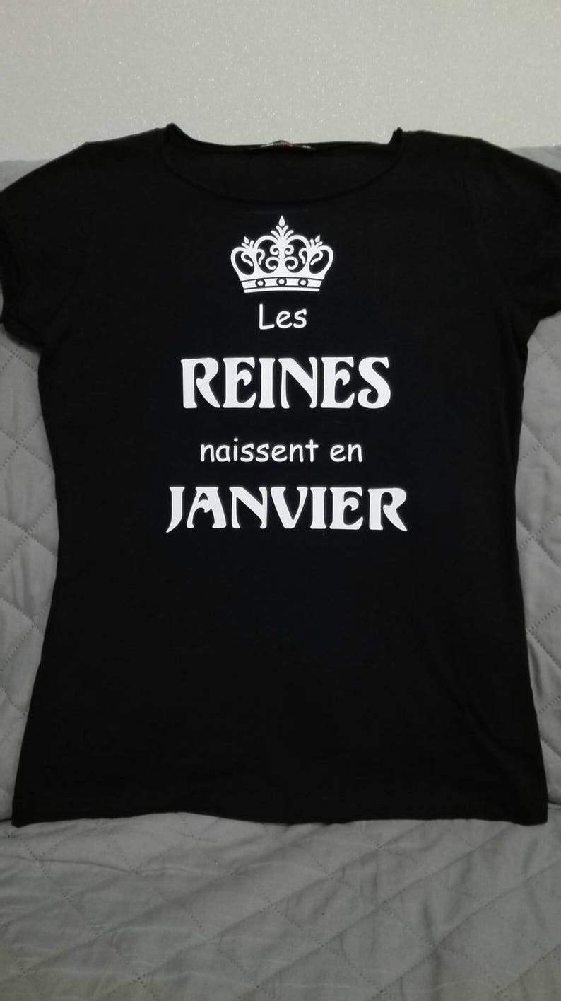 May include: Black t-shirt with a white crown graphic and the text "Les Reines naissent en JANVIER".
