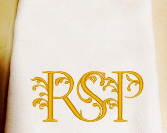 May include: White hand towel with a gold embroidered monogram of the letters RSP.