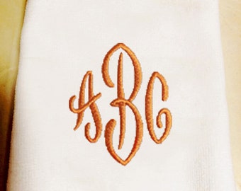 May include: White hand towel with a fringe border and a monogram embroidered in orange. The monogram is the letters ABC.
