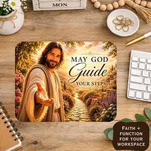 May include: A rectangular mouse pad featuring an illustration of a person with long hair and a beard reaching out a hand, with a stone path leading into a sunset landscape and the text "MAY GOD GUIDE YOUR STEPS" printed in black and gold.