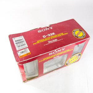 May include: A red box with the words "SONY" and "D-32K" printed on it. The box is for a Discman active speaker system. The box has a special package offer.
