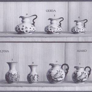 May include: A black and white photo of a set of eight ceramic pitchers and vases. The pitchers and vases are decorated with floral and leaf patterns. The pitchers and vases are arranged in two rows of four. The top row is labeled "Gerda" and the bottom row is labeled "Lydia". The photo is labeled "Mosa Maastricht Serie D."