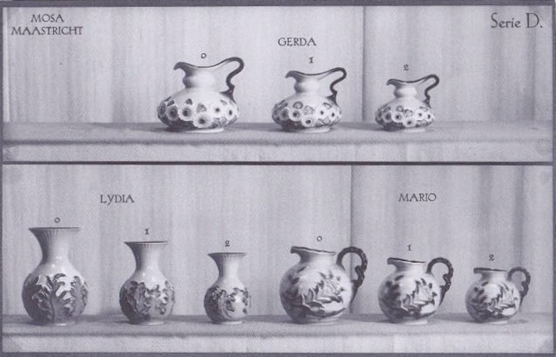 May include: A black and white photo of a set of eight ceramic pitchers and vases. The pitchers and vases are decorated with floral and leaf patterns. The pitchers and vases are arranged in two rows of four. The top row is labeled "Gerda" and the bottom row is labeled "Lydia". The photo is labeled "Mosa Maastricht Serie D."