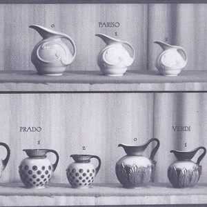 May include: A display of eight ceramic pitchers in various styles and sizes. The pitchers are arranged in two rows of four. The top row features pitchers with floral designs, while the bottom row features pitchers with polka dot and leaf designs. The pitchers are labeled with the names "Pariso", "Prado", and "Verdi". The text "Mosa Maastricht" and "Serie D." is also visible in the image.