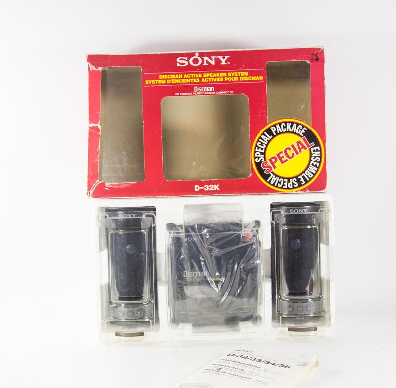 May include: A Sony Discman D-32K active speaker system in its original packaging. The box is red and white with the Sony logo and the words "Special Package" and "Ensemble Special". The system includes two black speakers and a black Discman player.