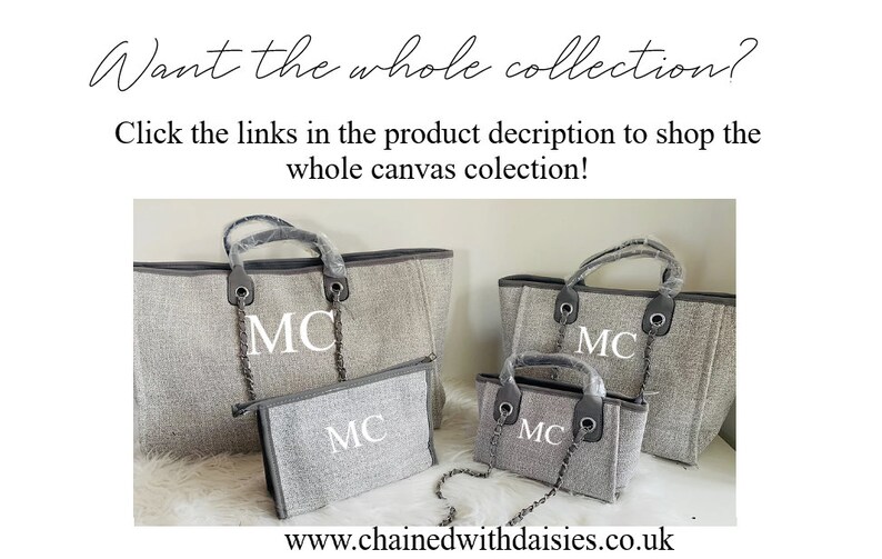 May include: Four gray canvas tote bags with black handles and silver chains. The bags are all different sizes and have the initials "MC" embroidered on the front in white.