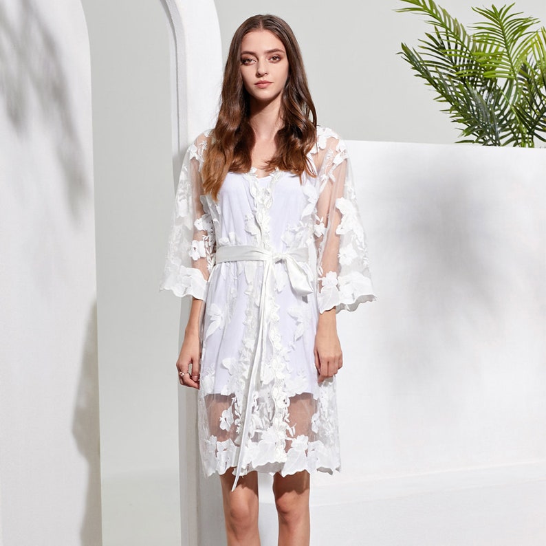 These are our Full Lace detail bridal robes, they are stunning and ideal to add to your bridal party for your big day.
These are beautiful and make  stunning bridal robe, and come personalised with yout new married name on the belt.

White lace robe for the bride and tropical print for the bridal party!