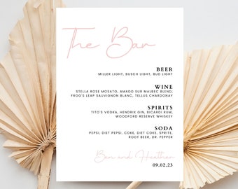 May include: A white card with black text listing the drinks available at a wedding reception. The card has the title "The Bar" in pink script and the date "09.02.23" at the bottom. The drinks are categorized as Beer, Wine, Spirits, and Soda.