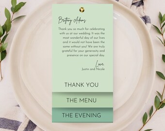 May include: A light green wedding thank you card with the text "Brittany Adams" and "Thank you so much for celebrating with us at our wedding. It was the most wonderful day of our lives and it would not have been the same without you! We are truly grateful for your generosity and presence on our special day. Love, Justin and Nicole." The card also has the text "Thank You", "The Menu", and "The Evening" on it.