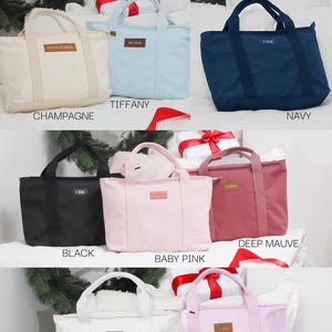 May include: Ten cotton canvas tote bags in various colors, including champagne, tiffany blue, navy, black, baby pink, deep mauve, white, and lilac. Each bag has a small leather patch with the word "CARAT" on it.