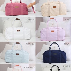 May include: A set of ten cotton canvas weekender bags in various colors, including deep mauve, champagne, white, lilac, tiffany, baby pink, navy, and black. Each bag features a brown leather handle and a small leather patch with the word "BM" or "MAFTER" embossed on it.