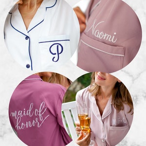 May include: Four different pajamas with embroidered text. One white pajama top with a navy blue trim and a navy blue letter "P" embroidered on the pocket. One pink pajama top with "Naomi" embroidered on the pocket. One pink pajama top with "maid of honor" embroidered on the back. One pink pajama top with "M.F.C" embroidered on the pocket.