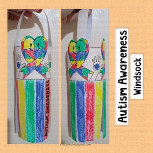 May include: A craft project for making a windsock to celebrate Autism Awareness Month. The windsock is made from a paper tube and decorated with a colourful puzzle piece heart, a hand with a puzzle piece, and stripes of coloured paper.