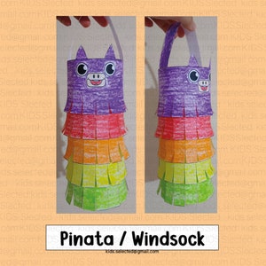 May include: A purple, orange, yellow, and green paper pinata or windsock with a cartoon animal face. The pinata or windsock has a loop at the top for hanging.