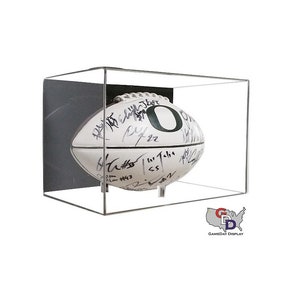 May include: A white football with black signatures and a green "O" on it is displayed in a clear acrylic case with a black backing. The case is on a white surface. The text "GAMEDAY DISPLAY" is visible in the bottom right corner of the image.