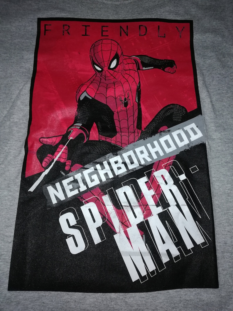 May include: Grey t-shirt with a Spider-Man graphic in red and black. The design includes the words "FRIENDLY NEIGHBORHOOD SPIDER-MAN" in white and grey text against a red and black background.
