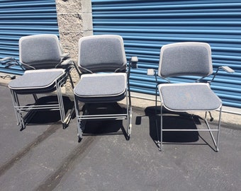 Vintage Stacking Arm Chairs , metal with upholstered seats and backs ( 13 available)
