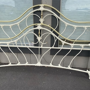 May include: White metal bed frame with gold accents and a decorative heart design.