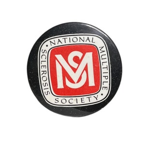 May include: A black and white button with a red square in the center. The square has the letters "MS" in white. The button reads "National Multiple Sclerosis Society".