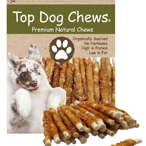 May include: A bag of Top Dog Chews premium natural dog treats. The bag features a paw print logo and text that reads "Organically Sourced, No Hormones, High in Protein, Low in Fat". The treats are long, thin, and twisted, with a light brown color.