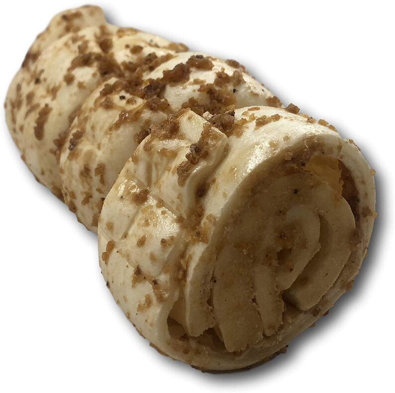 May include: A rolled dog chew treat with a brown, crunchy coating. The chew is made of a light brown, soft material.