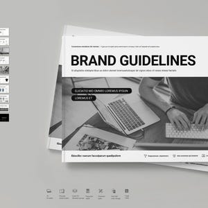 May include: A black and white image of a person using a laptop computer. The text "BRAND GUIDELINES" is at the top of the page. The text "EDUCATIO MO OMNO LOREMUS IPSUM" and "LOREMUS ET" are in white boxes on the page. The text "example" is in a circle at the top right corner of the page.